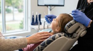 Dental hygienist examining child's teeth during preventive cleaning appointment with parent present at View Dental Raleigh